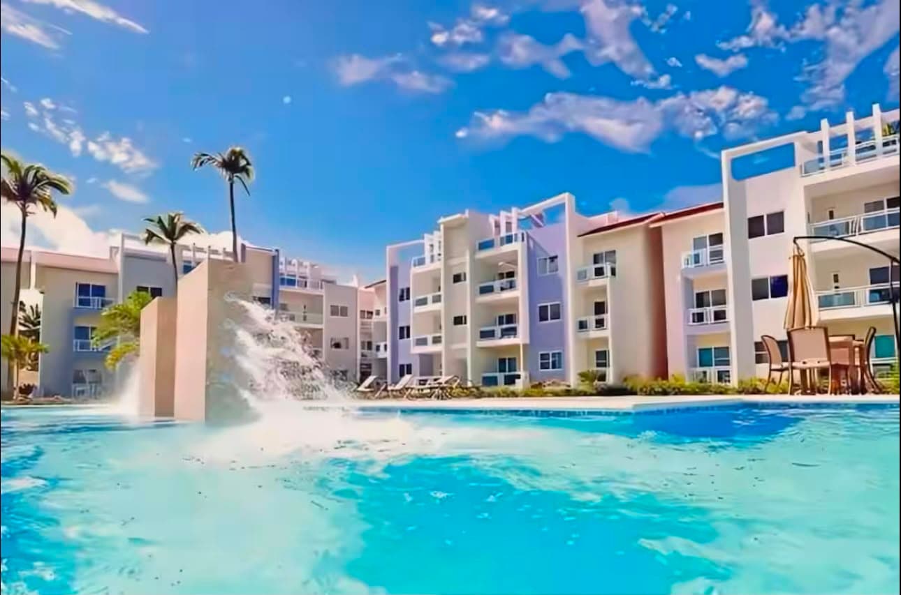 Palm-lined pool and residences in Punta Cana